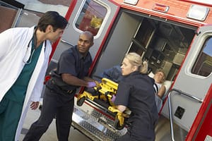Paramedics unloading patient from ambulance