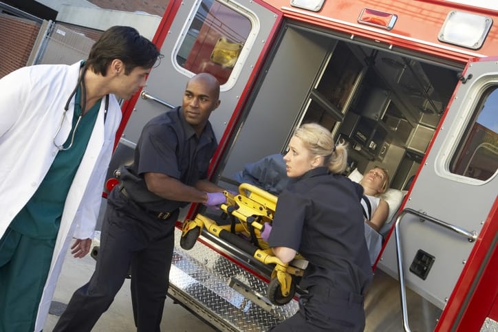 Paramedics unloading patient from ambulance